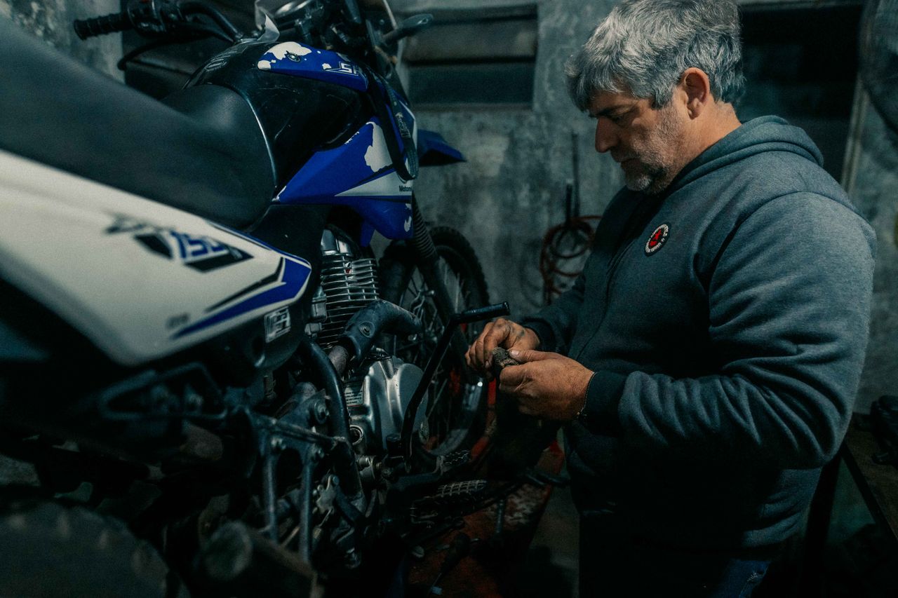 Aftercare & Support Close-up work on a motorcycle engine during routine maintenance