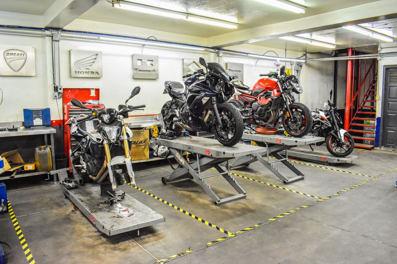 Used motorcycles on stands during the pre-sale checking routine