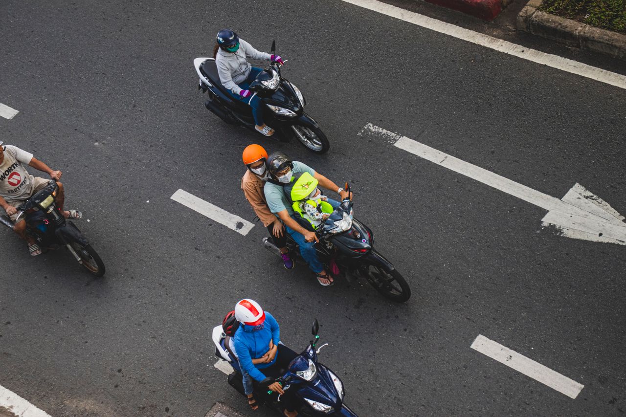 Riders in protective kit on an urban road, illustrating everyday riding use